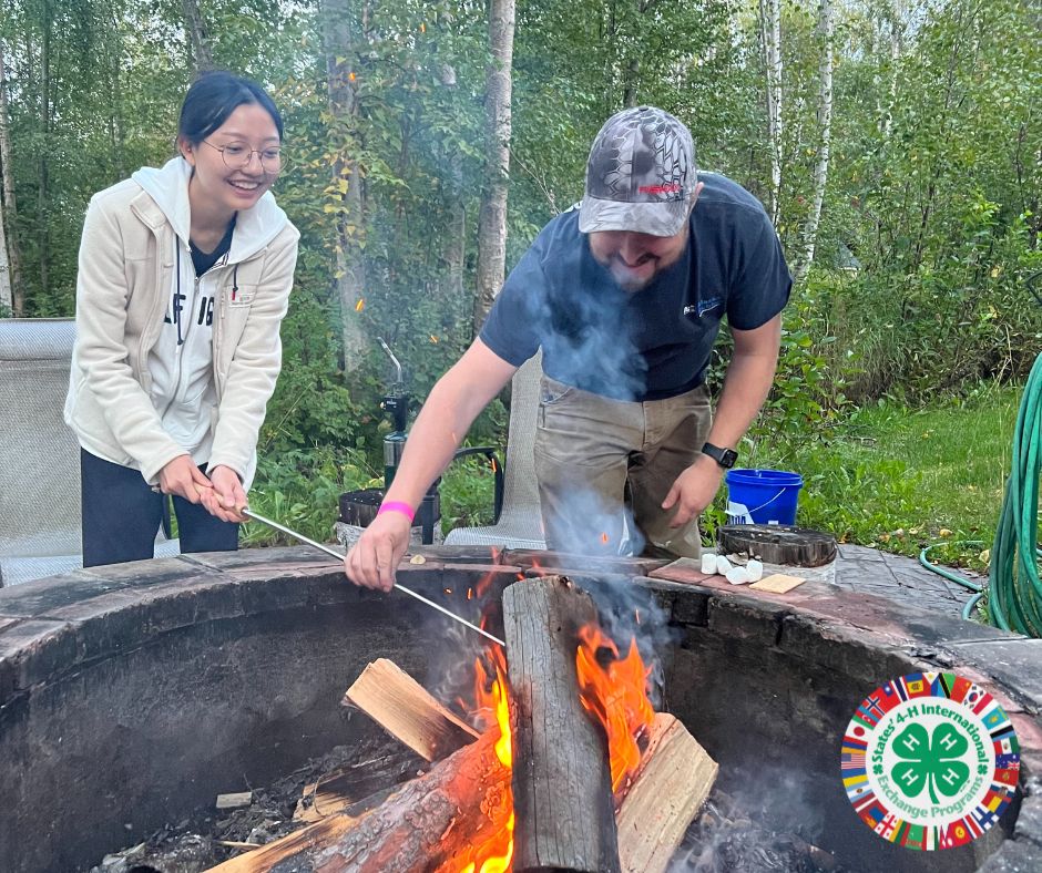 Exchange Student Making Smores with Host Father